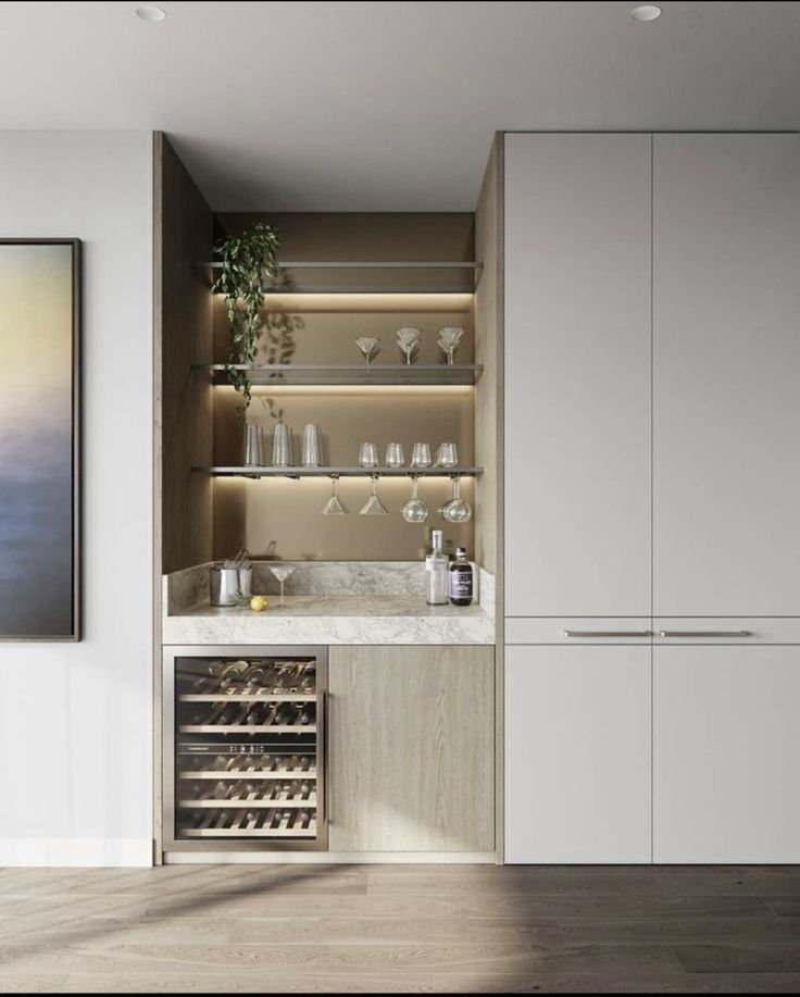 a wine rack in the corner of a room with white cabinets and glassware on it