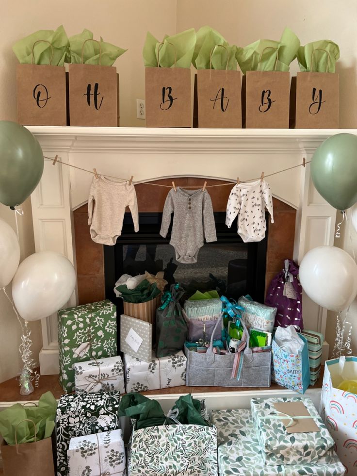 a fireplace with presents and balloons in front of the mantel decorated for a baby shower