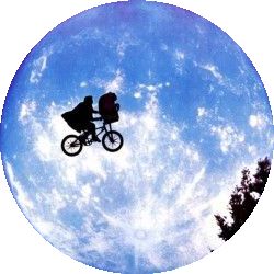 a person on a bike flying through the air in front of a blue sky with clouds