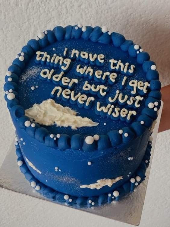 a blue birthday cake with white frosting and writing on the top that says, i have this thing where i get older but never wise