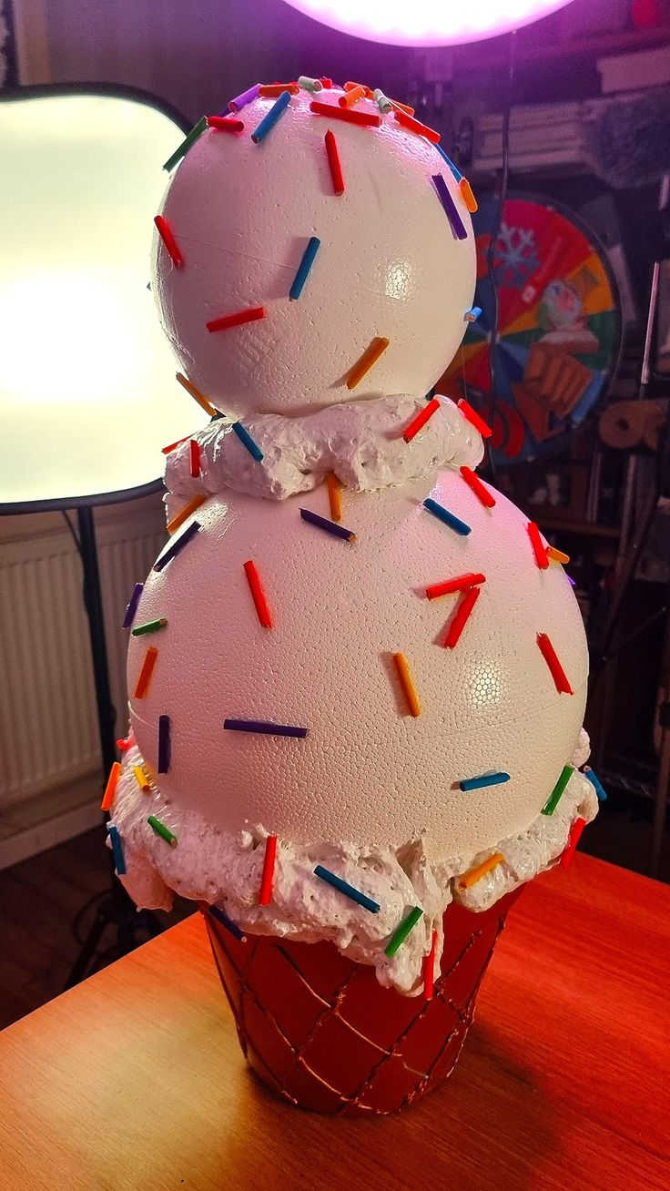 an ice cream sundae with sprinkles on top sits on a table