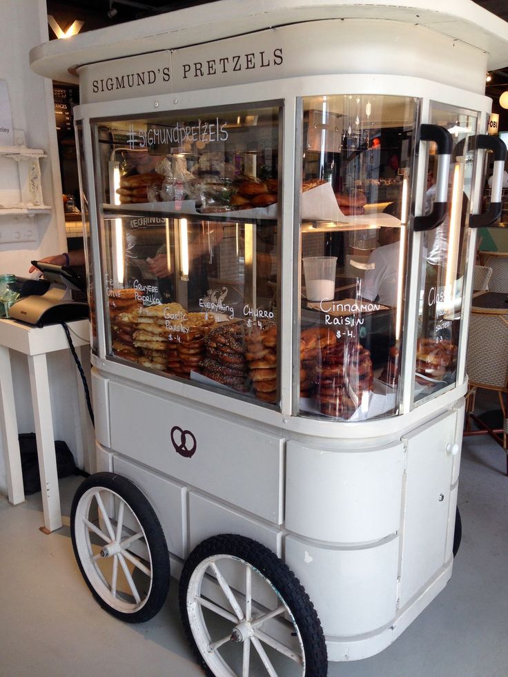 a white cart filled with donuts and pastries