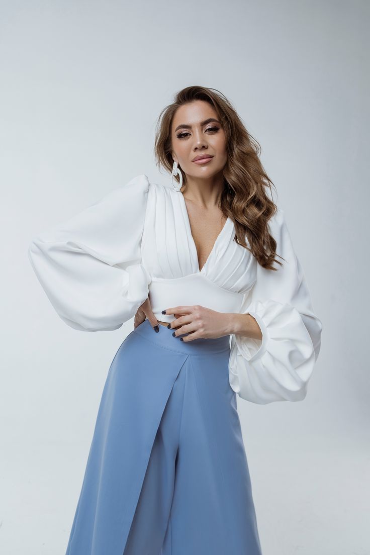 This puff-sleeve V-neck blouse is the epitome of elegance. The puffed sleeves create a flattering silhouette, while the backless design adds a touch of sexiness. Dress it up with high-waisted culottes from our collection. #puffsleeveblouse #vneckblouse #backlessblouse #femininefashion #sophisticatedstyle #elegantblouse #statementtop High Waisted Culottes, Kibbe Romantic, Puff Sleeves Top, Full Sleeve Top, Red Shawl, Backless Blouse, Wear Store, Backless Design, Elegant Blouses