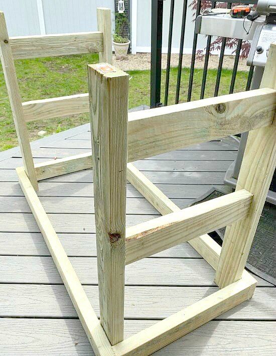 a wooden bench sitting on top of a wooden deck