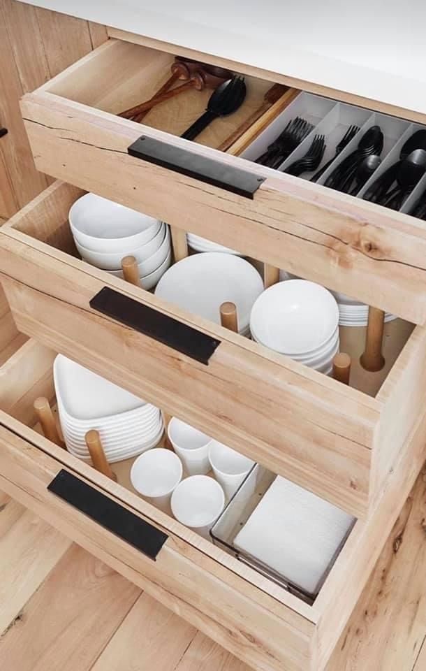 an open drawer with dishes in it and the words how to finally organize your kitchen cabinets