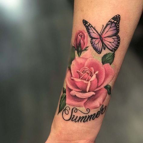 a woman's arm with a pink rose and butterfly on it