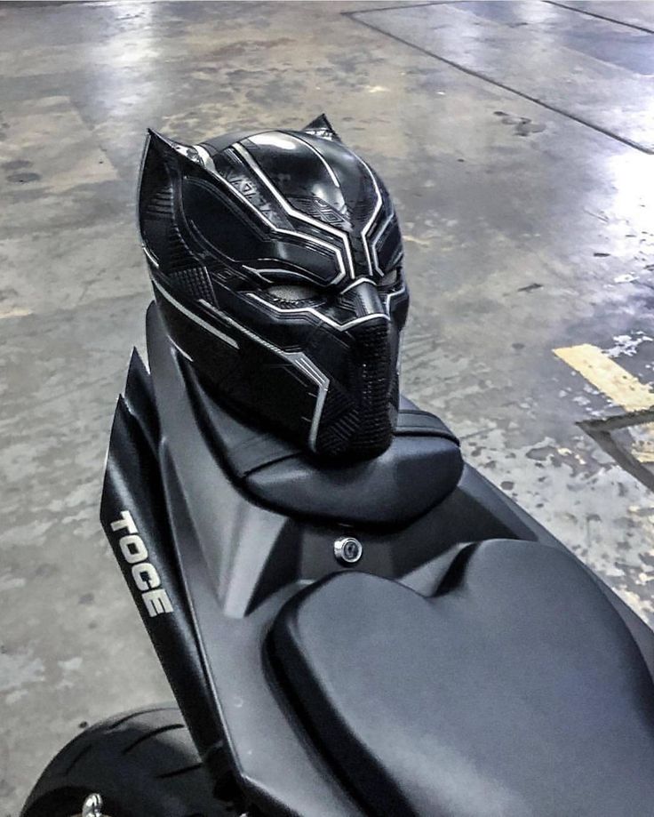 a black motorcycle with a helmet on it's seat