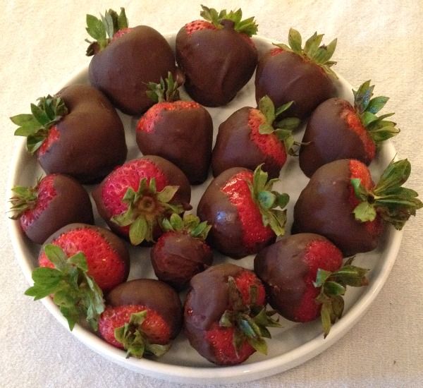 chocolate covered strawberries in a bowl on a table