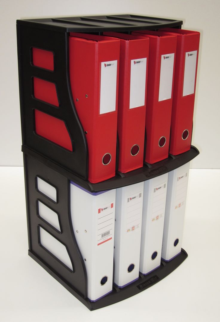 red and white binders stacked on top of each other in a black holder with four file folders