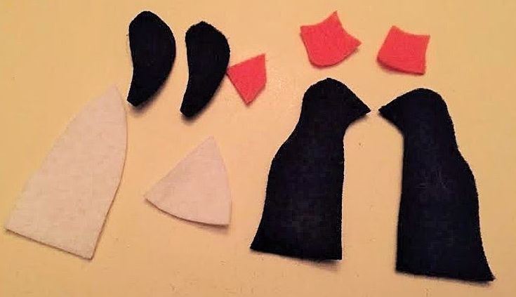 three pieces of fabric with red and black felt on top of each other, including one piece of cloth that has been cut out