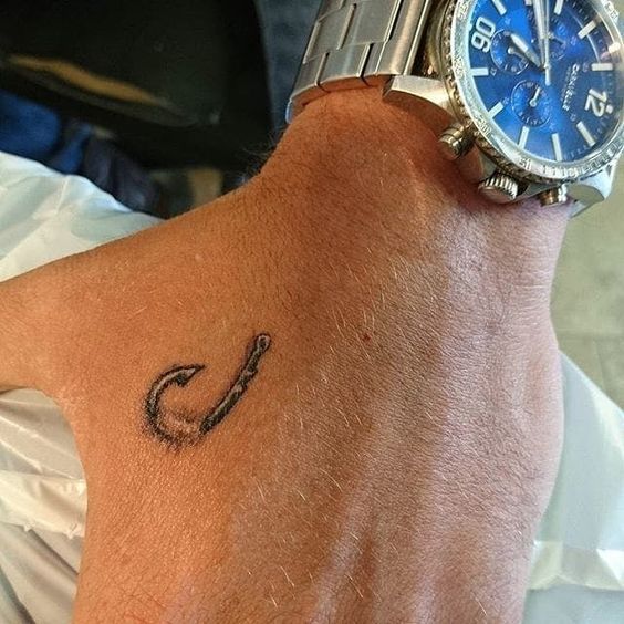 a man with a tattoo on his wrist