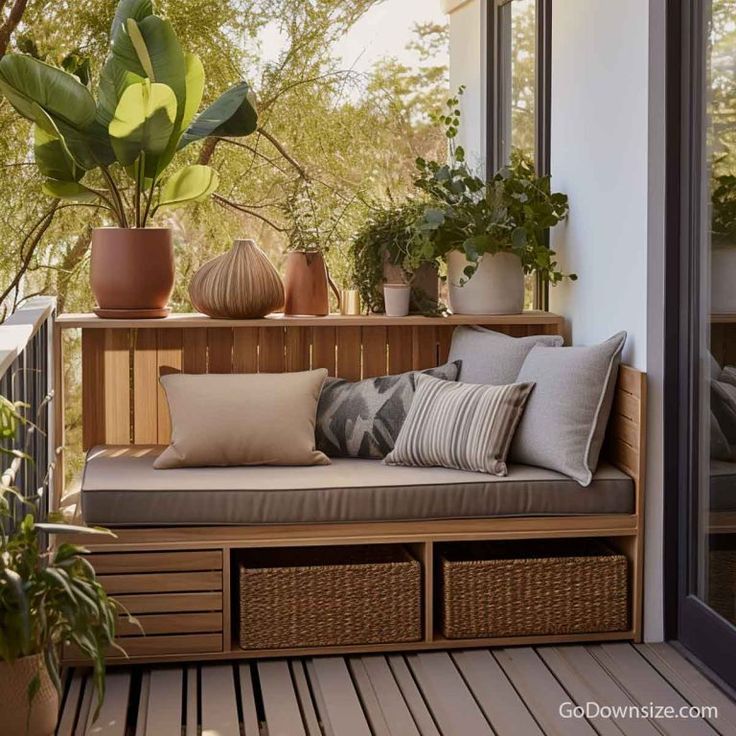 a wooden bench sitting on top of a wooden floor next to potted plants and windows