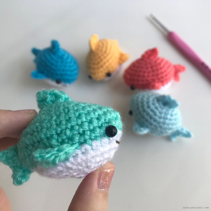 crocheted fish amigurt toy being held up by someone's hand