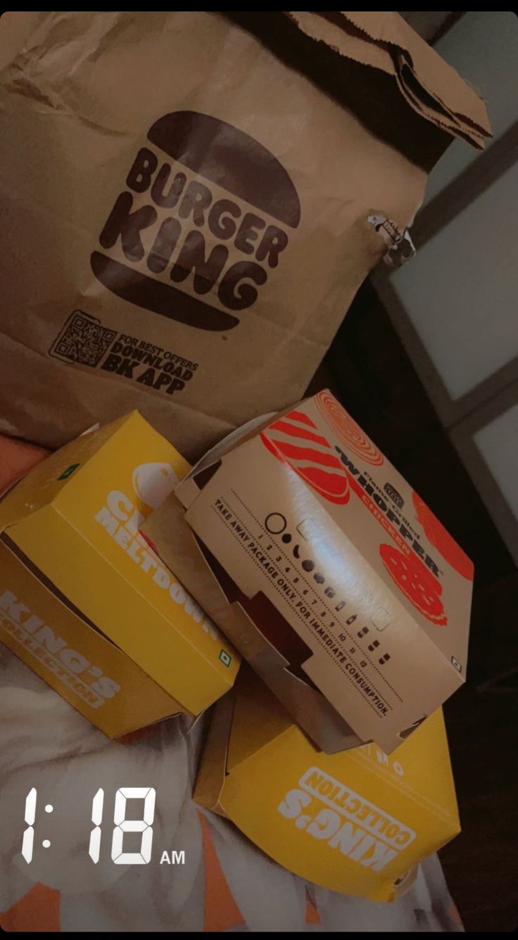 the burger king bag is sitting on top of some boxes