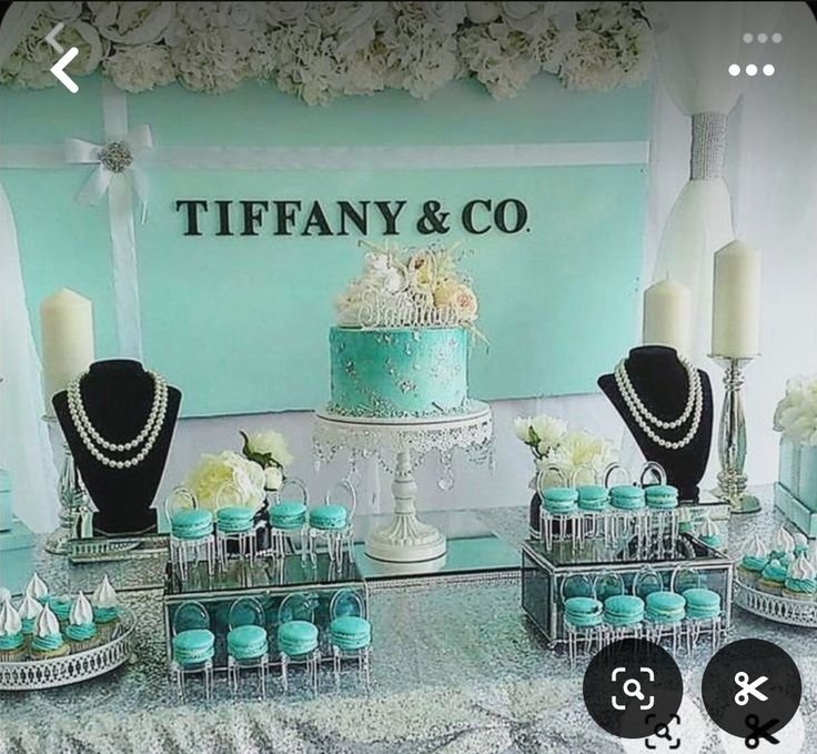 a table topped with cakes and cupcakes covered in frosting