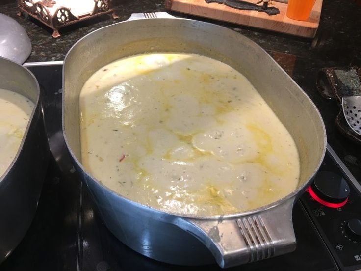 two pans filled with food sitting on top of a stove next to each other