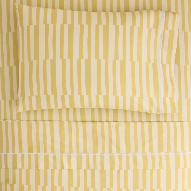 a yellow and white striped bed sheet set