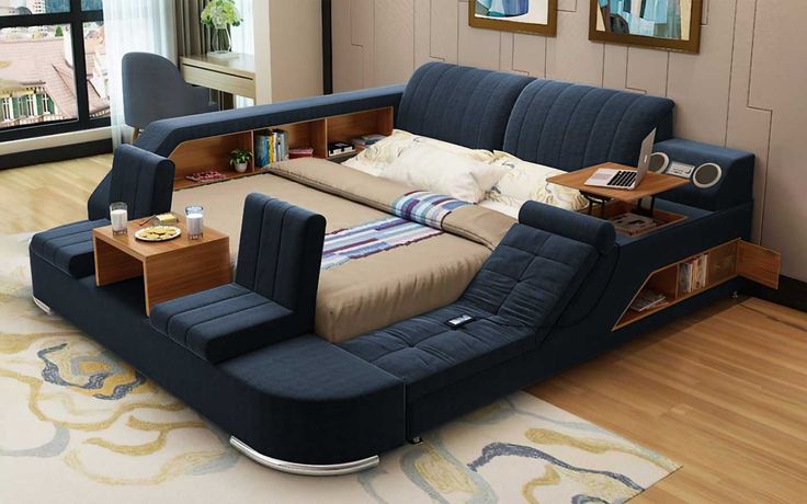 a bed that is sitting in the middle of a room with a book shelf on top of it