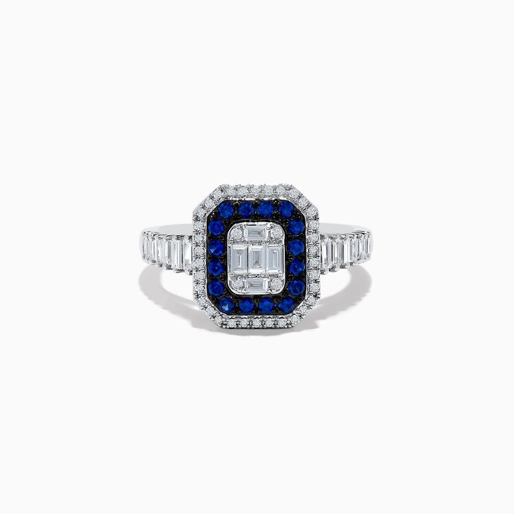 a blue and white diamond ring with two baguettes on the side, set in 18k white gold