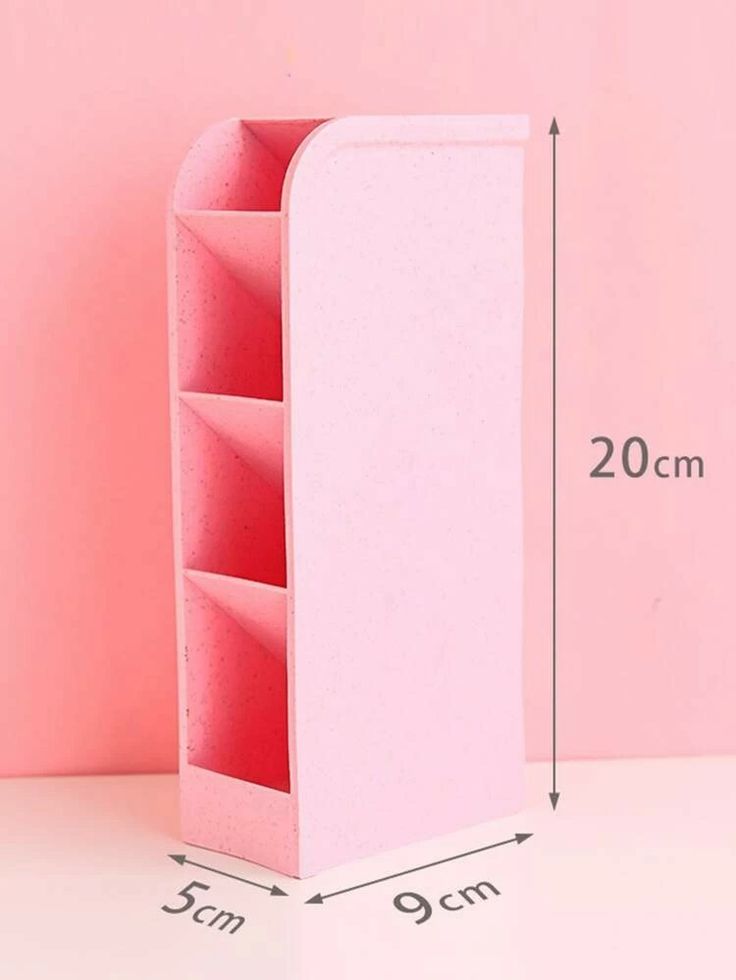 a pink shelf with two compartments and measurements for the bottom section, on a light pink background