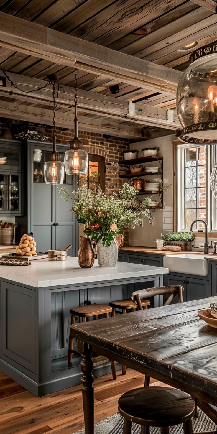 a rustic kitchen with an island and wooden table in the center, surrounded by hanging lights