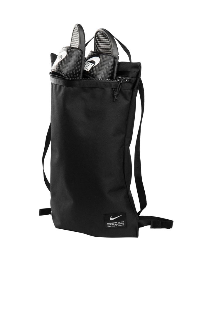 a black bag filled with shoes on top of a white background's back ground