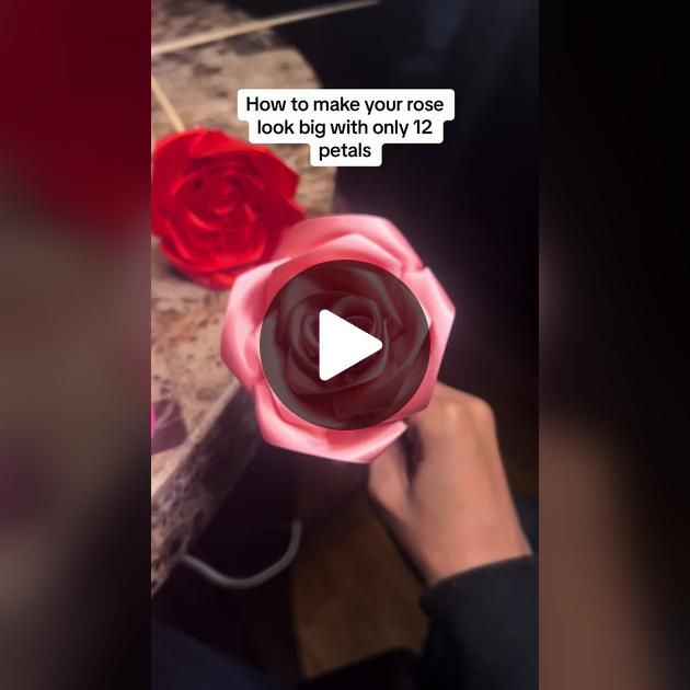 a person holding a red rose in their hand with the caption how to make your rose look big with only 12 petals