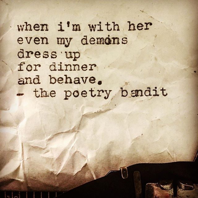 an old typewriter with a piece of paper on it that says, when i'm with her even my demons dress up for dinner and behave, the poetry band