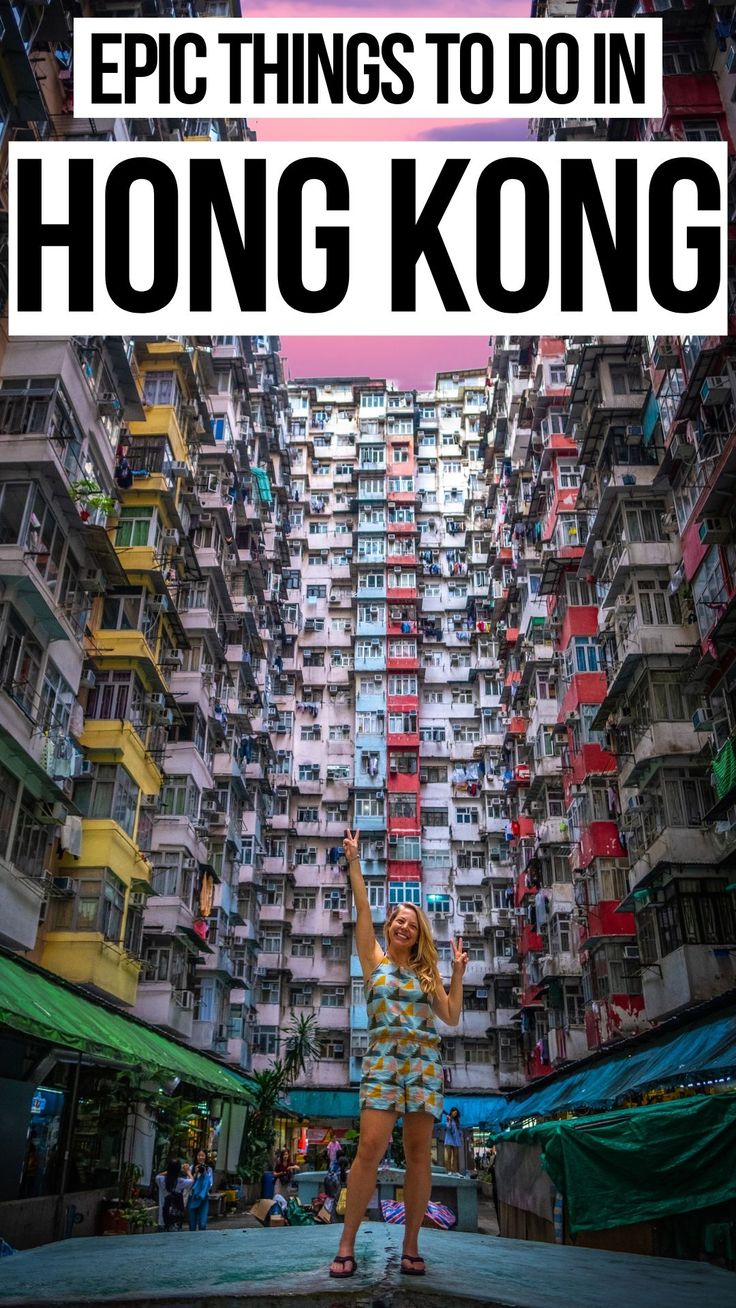 a woman standing in front of tall buildings with the words epic things to do in hong kong