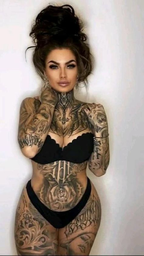 a woman with tattoos on her body posing for the camera