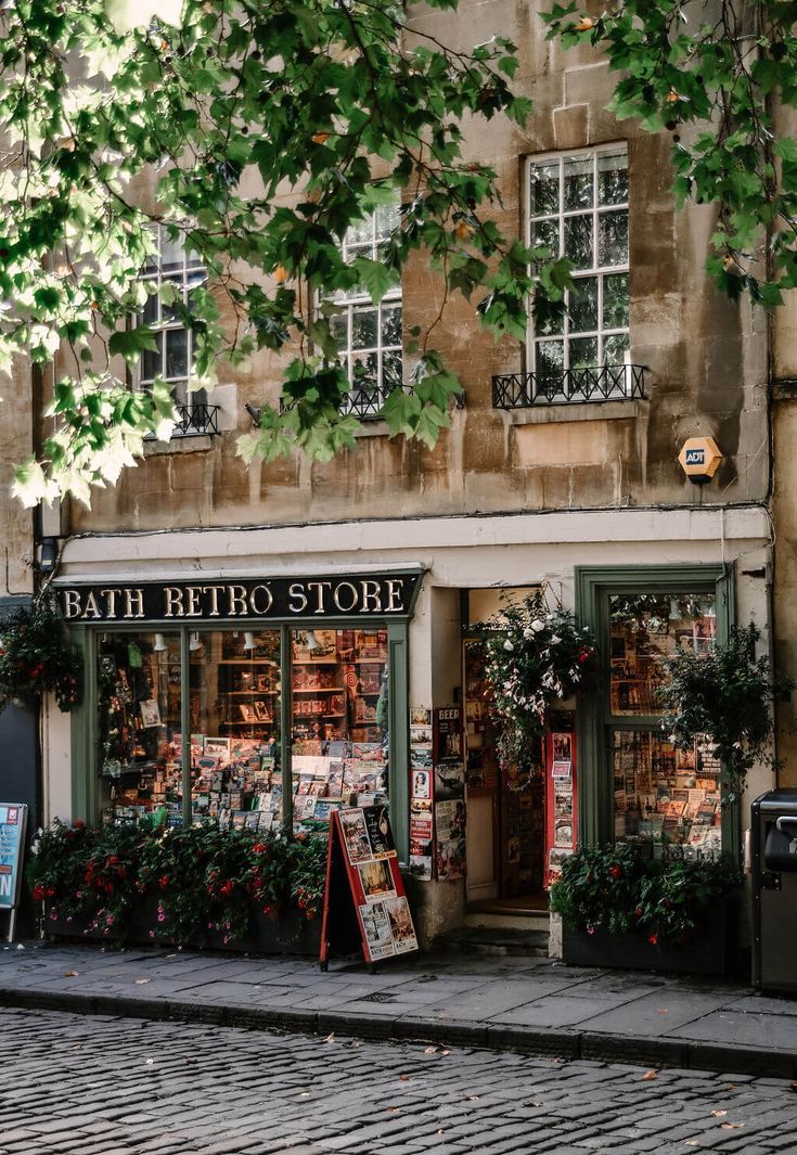 a store front with lots of plants in the window