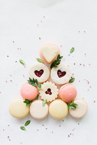 some cookies are arranged in the shape of a pyramid with hearts and flowers on top