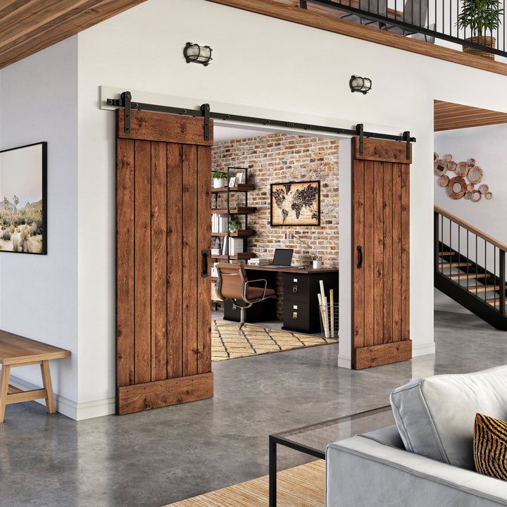 a living room filled with furniture next to a brick wall and wooden sliding barn doors