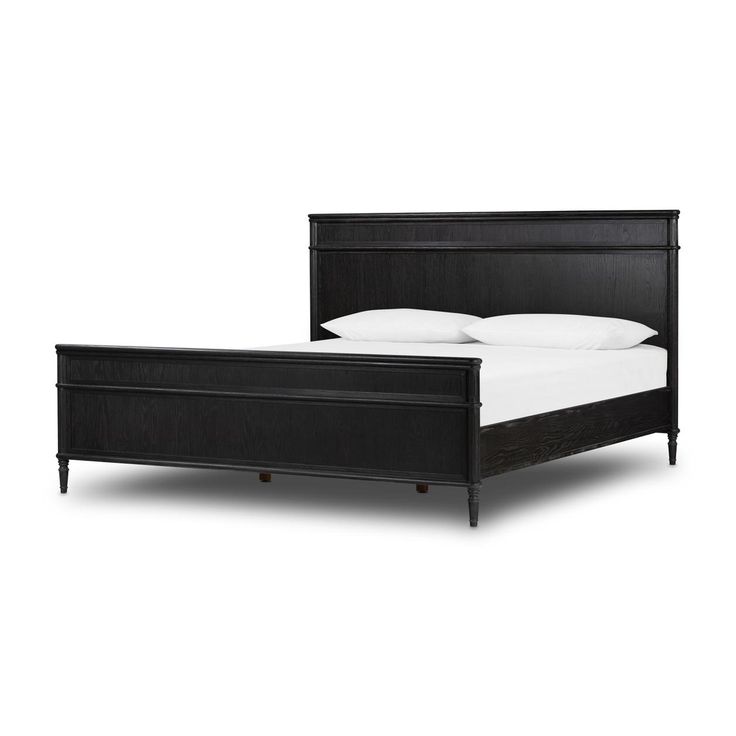 a black bed frame with white sheets and pillows