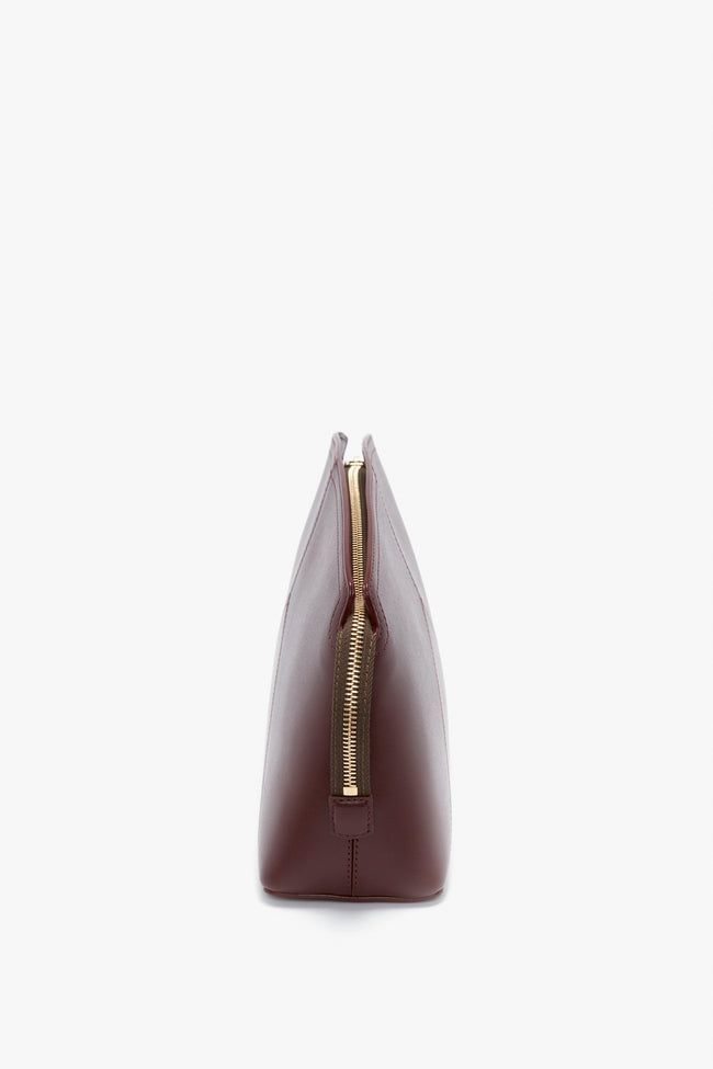 This glossy Clutch Bag brings a brand-new silhouette to Victoria Beckham's seasonal leather goods edit.  Presented in sophisticated Burgundy, it has a structured design, with an elegant curved top. It also embraces a new hardware language, with a branded padlock serving as zipper and closure and a snap button at one side to hold the zip tail in place. Leather panels stitched to form a V shape complete the look. Victoria Beckham Victoria Clutch Bag In Burgundy Leather  - Size ONE SIZE UK Luxury Rectangular Office Pouch, Chic Travel Clutch With Smooth Grain, Office Clutch Bag With Leather Lining, Brown Smooth Grain Evening Bag, Classic Rectangular Office Pouch, Elegant Brown Clutch With Smooth Grain, Timeless Everyday Clutch With Removable Pouch, Timeless Leather Clutch For Business, Timeless Top Handle Clutch For Everyday Use