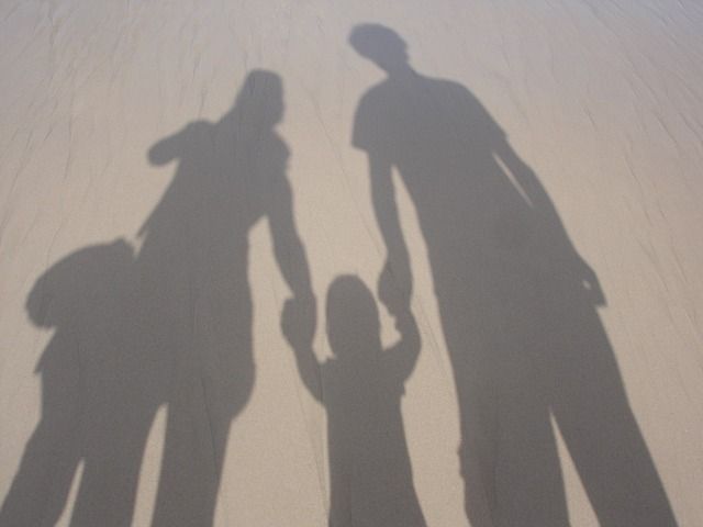 the shadow of two people holding hands and standing next to each other with text that reads natural organized parent