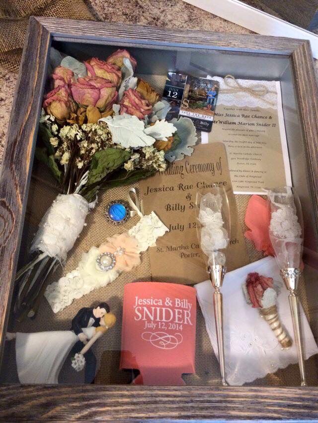 a wooden box filled with lots of different items and flowers on top of a table