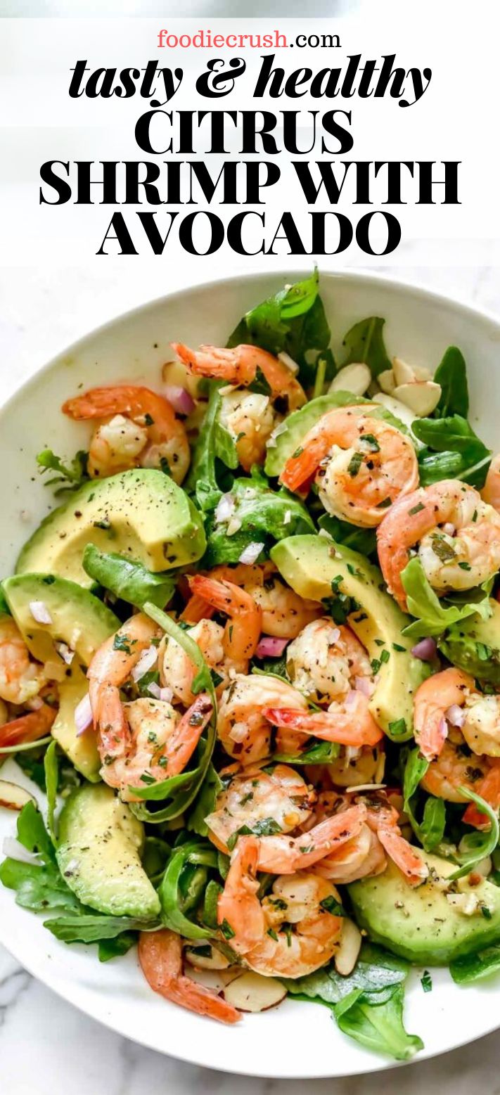 a white bowl filled with shrimp and avocado salad on top of a table