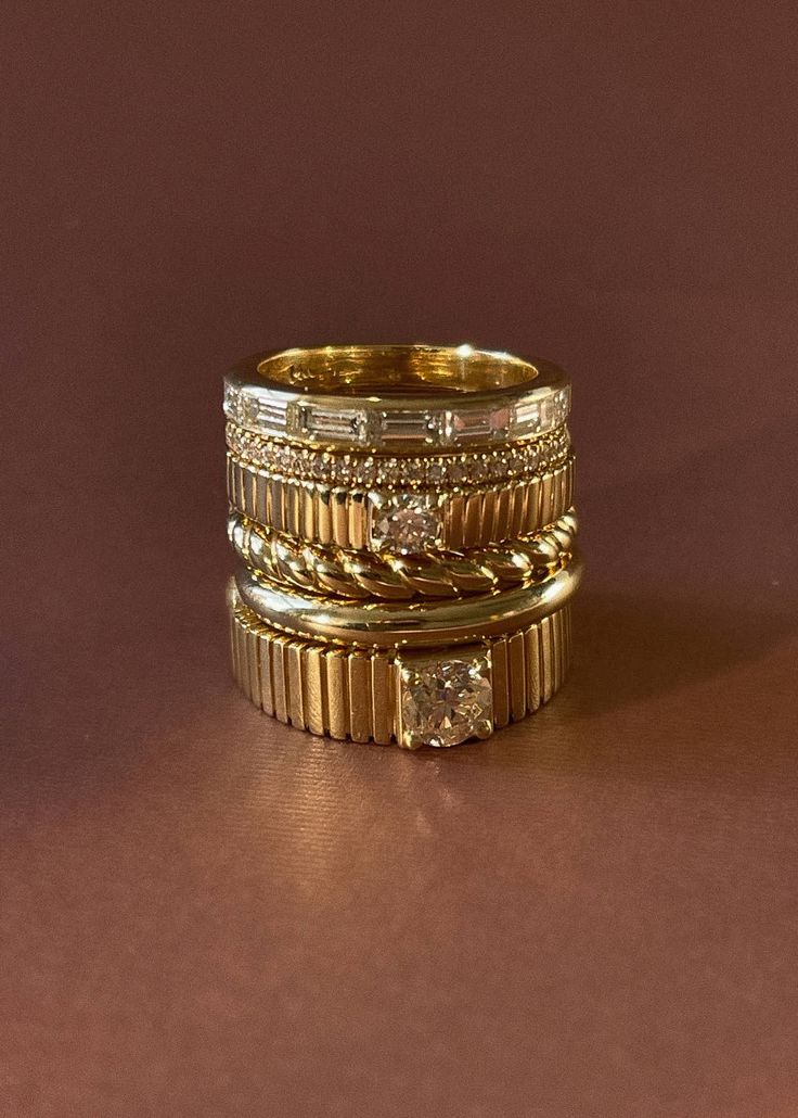 Inspired by Jennie's husband's grandmother's wedding ring, this ring is a perfect circle with soft-edges giving it the appearance of being worn for decades, just as she has worn hers. This is a signature, timeless piece you'll wear for every occasion. 14k solid gold—always Average weight: 2.8g Band width: 2.7mm (front), 1.8mm (back) Height off of finger: 2.4mm This piece cannot be engraved Heirloom Stackable Rings With Single Diamond, Ribbed Ring, Rib Ring, Vintage Inspired Engagement Rings, Fall Rings, Solid Gold Band, Classy Jewelry, Twist Ring, Jewelry Lookbook