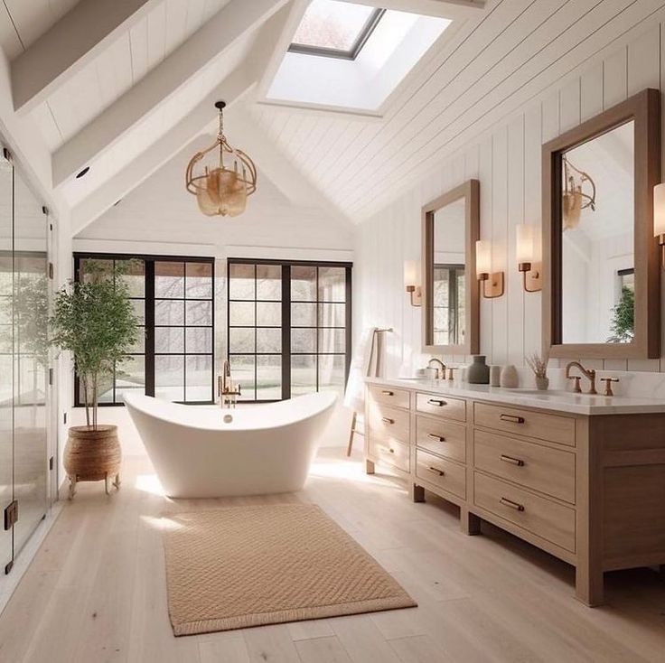 a large white bath tub sitting inside of a bathroom next to two sinks and mirrors