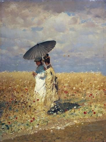 two women in a field with an umbrella