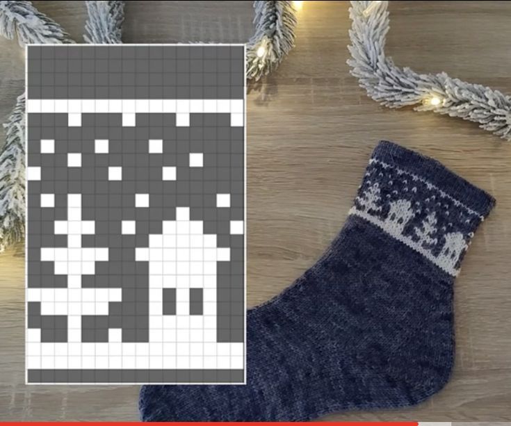 a knitted christmas stocking sitting on top of a wooden floor next to a pair of socks