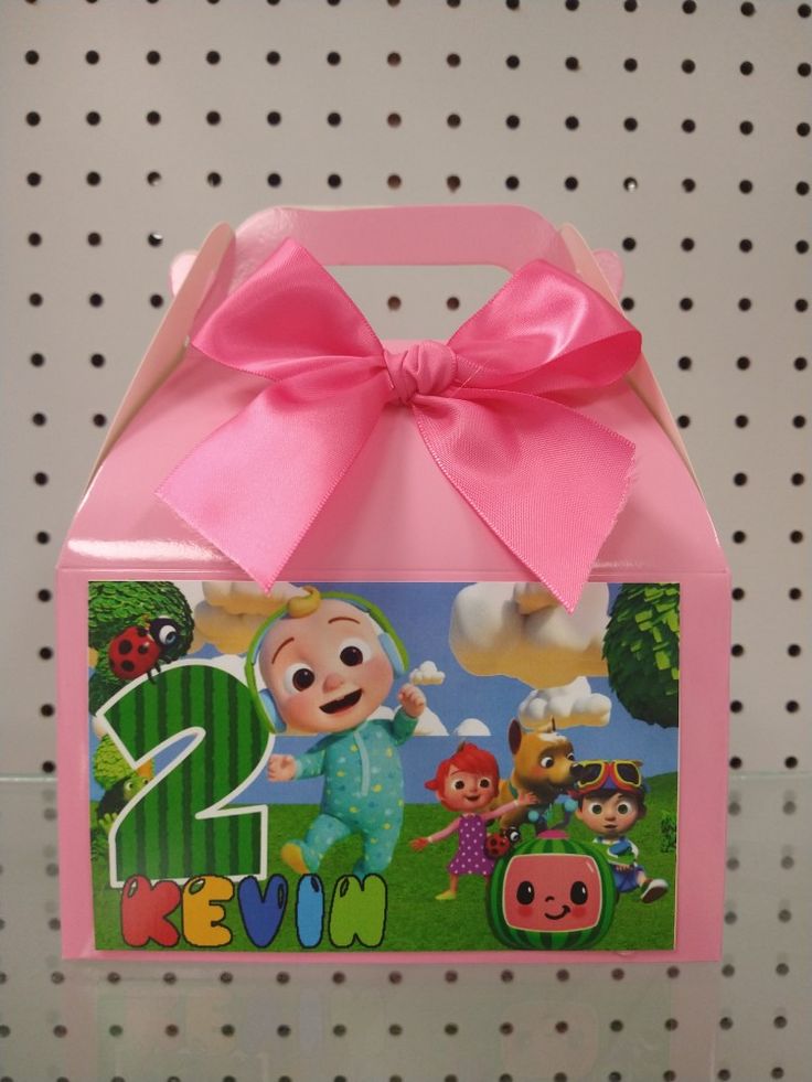 a pink box with a cartoon character on it and a pink bow around the top