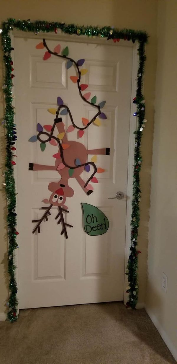 a door decorated with christmas lights and decorations