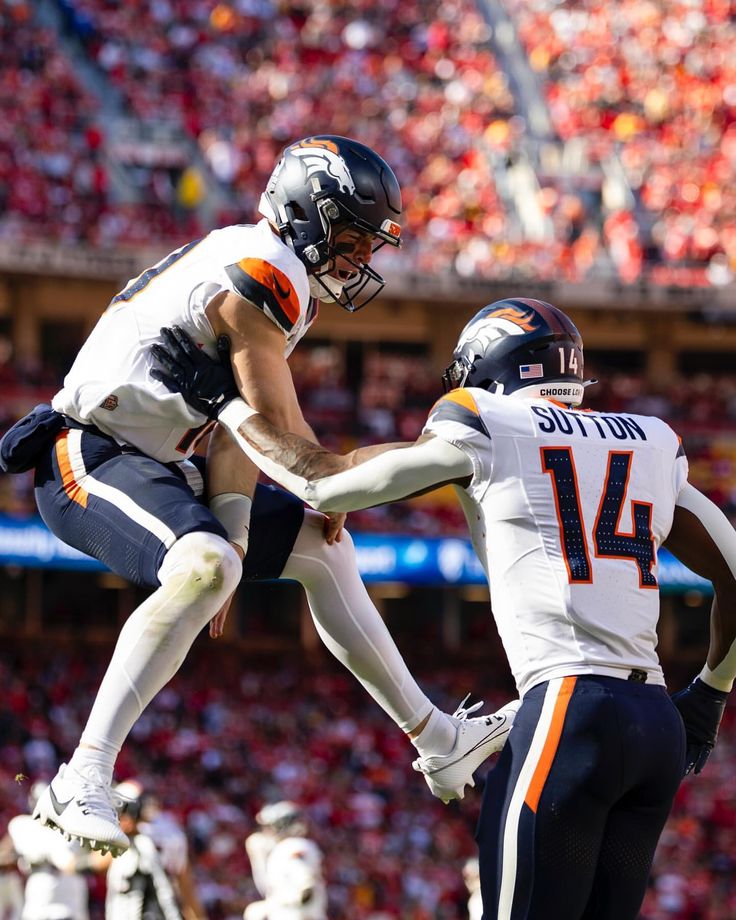 two football players in the air during a game