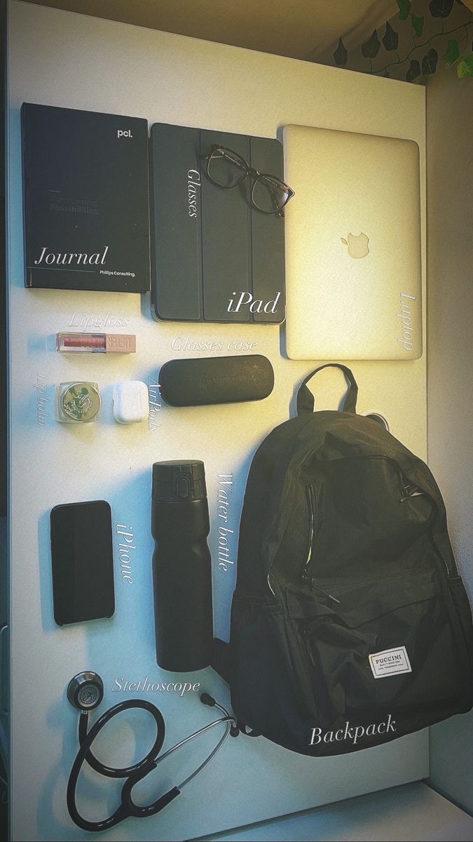 the contents of an apple backpack are displayed on a white surface with other items surrounding it