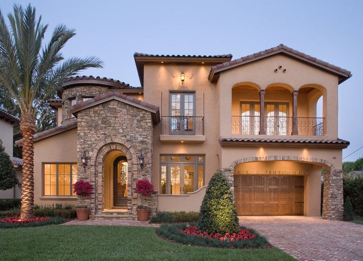 a large house with two garages and lots of windows