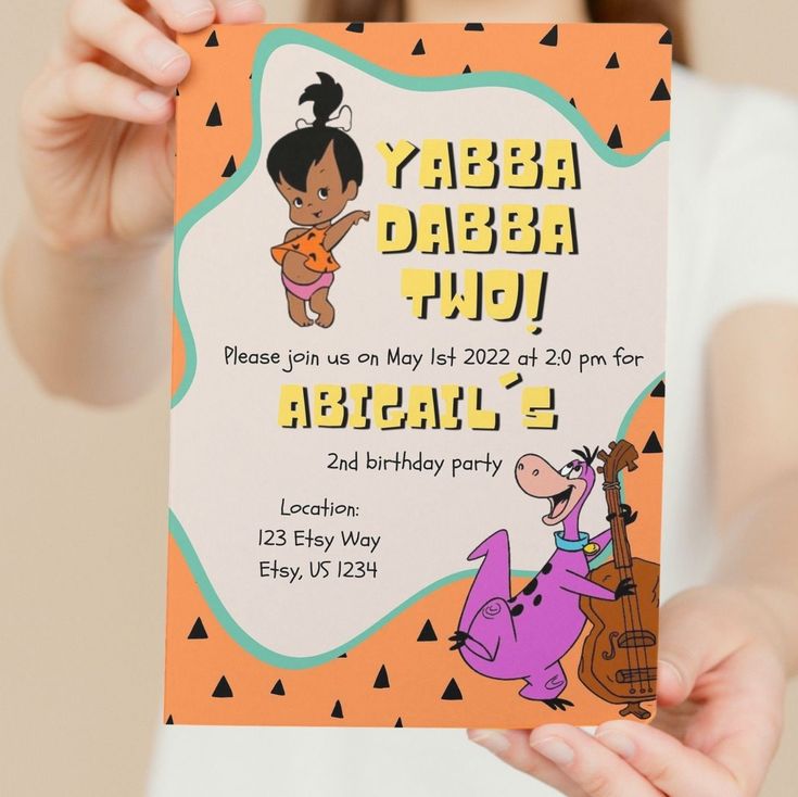 a person holding up a birthday card with an image of a cartoon character on it