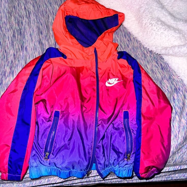 Used But Still In Absolute Perfect Condition. Literally Still Looks Brand New. This Is The Cutest Lightweight Full Zip Nike Jacket. Perfect For Fall Spring Or Winter. It’s So Colorful And Vibrant. It’s Pink Purple And Blue Ombr And With The Right Pair Or Air Max, Or Whatever Nike Kicks You Prefer, It Will Make The Your Little One Look Like The Most Fresh Dressed Around. I’m So Sad My Son Outgrew It. Some Pieces Of Clothing Are Hard To Let Go Of And This Definitely Being One Of Them Nike Pink Sports Outerwear, Nike Pink Sporty Outerwear, Sporty Pink Nike Outerwear, Purple Hooded Sports Outerwear, Purple Hooded Windbreaker With Pockets, Nike Purple Outerwear For Streetwear, Nike Purple Long Sleeve Outerwear, Pink Nike Windbreaker For Winter, Nike Pink Windbreaker For Winter