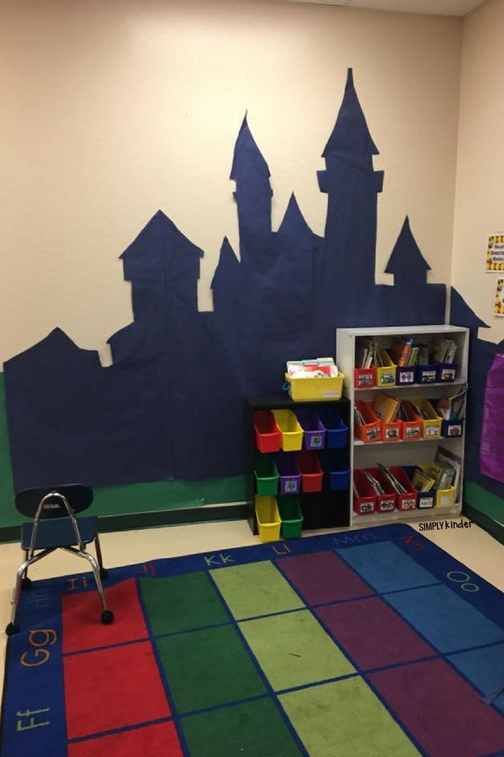 a child's playroom with colorful carpet and castle mural